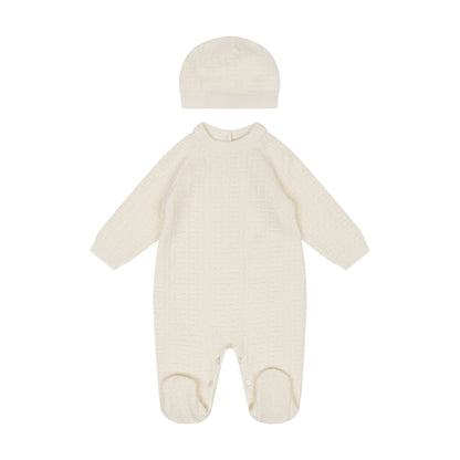 Cream-colored baby onesie with matching hat on a white background