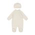 Cream-colored baby onesie with matching hat on a white background