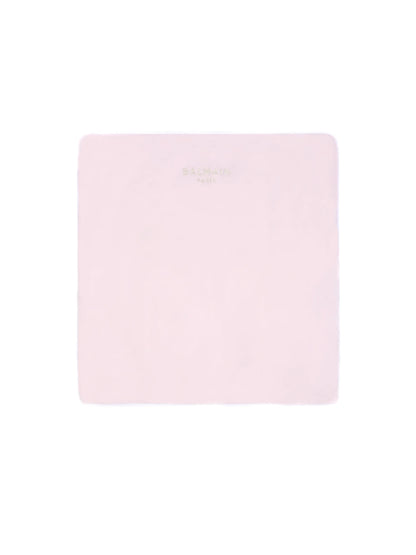 Pink square with a brand logo on a light pink background