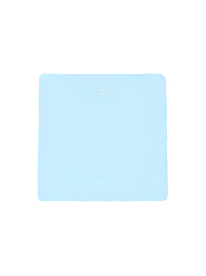 Light blue mouse pad with brand name on a beige background